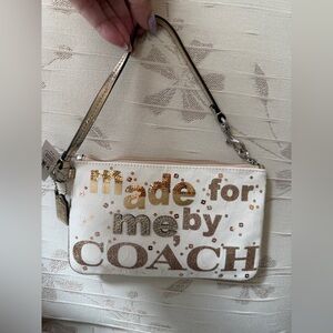 Nwt Coach cream canvas Wristlet with Gold Sequin Accents